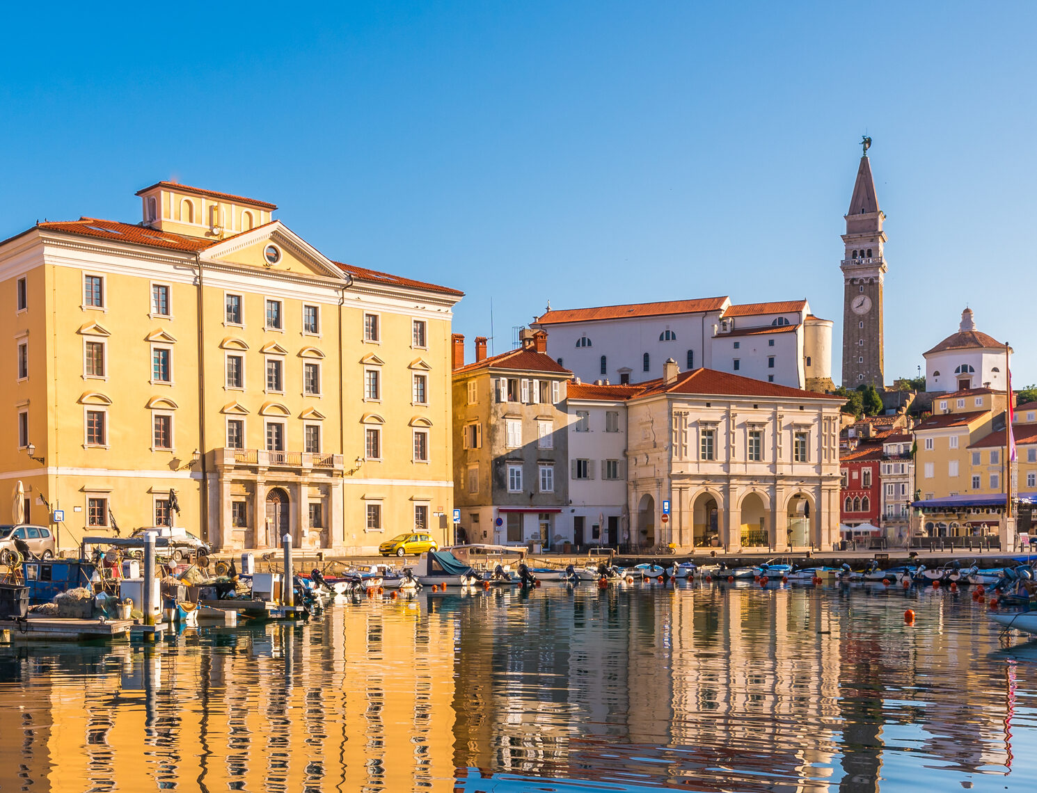 Buildings of Piran Old Town Reflected in Water.